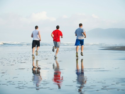 Men running on beach