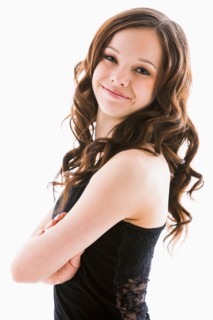 Portrait of smiling girl (12-13) with arms crossed