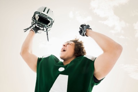 Portrait of American football player celebrating victory