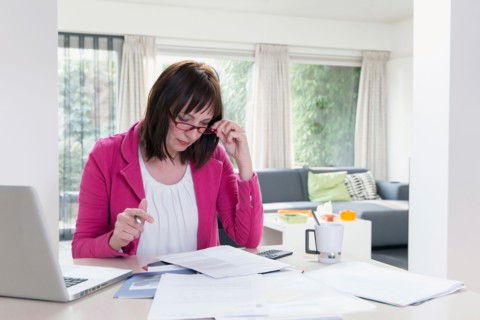 Mature businesswoman doing paperwork