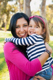Portrait of smiling mother and daughter (4-5 years) hugging