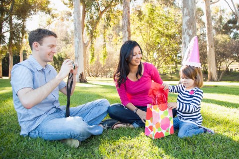 Family with daughter (4-5) playing in park