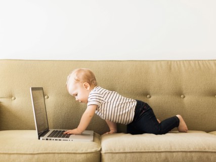 Baby girl (12-17 months) using laptop