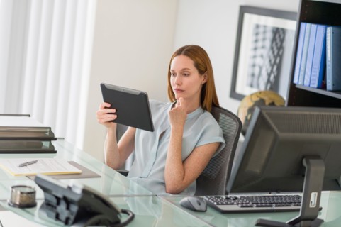 Business woman using tablet pc in office.