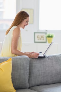 Woman using laptop at home.