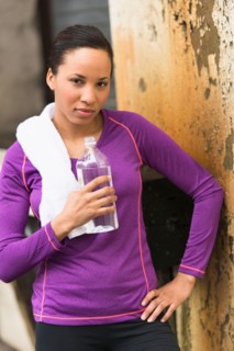 Portrait of female jogger with water bottle.