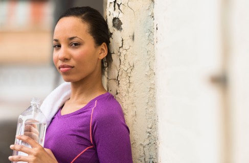 Portrait of female jogger with water bottle.