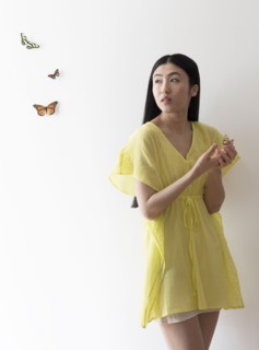 Studio shot of woman looking at butterflies.