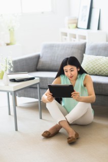 Woman using tablet pc at home.