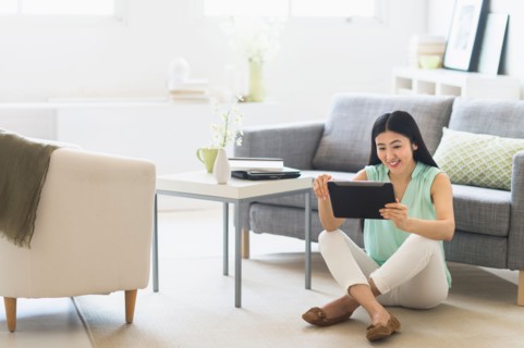 Woman using tablet pc at home.