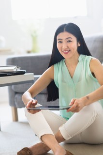 Portrait of woman using tablet pc at home.
