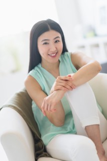 Portrait of woman sitting in armchair.