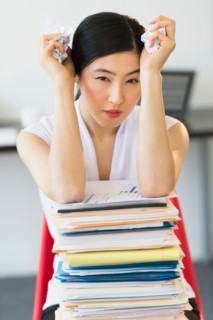 Portrait of businesswoman with stack of files.