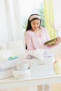 Woman donating household items.