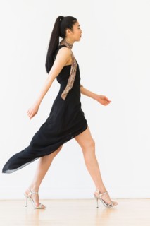 Woman wearing elegant black dress.