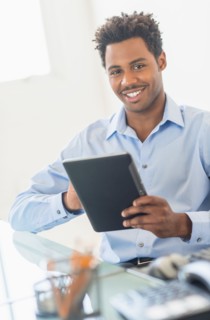 Businessman using tablet PC in office.