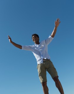 Happy man against clear sky.