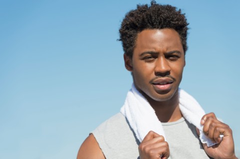 Athlete with towel on neck.