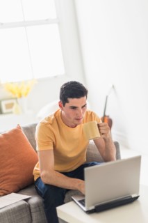 Man using laptop at home.