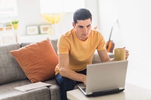 Man using laptop at home.