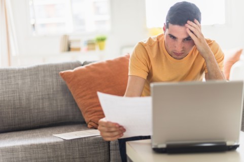 Man using laptop at home.