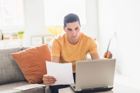 Man using laptop at home.