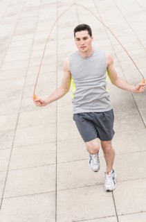 Man exercising with jumping rope.