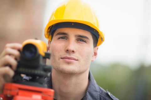 Engineer using theodolite.