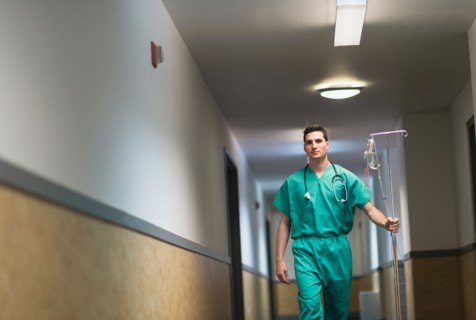 Doctor walking in hospital corridor.