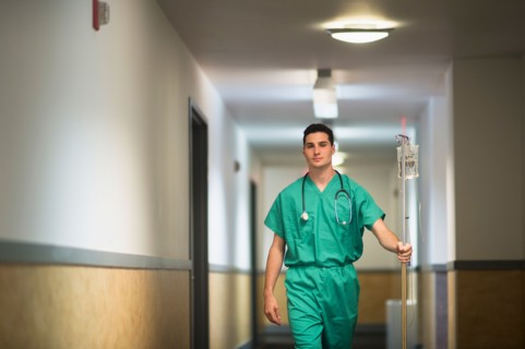Doctor walking in hospital corridor.