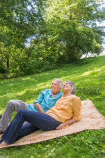 Central Park, New York City. Senior couple relaxing in park.
