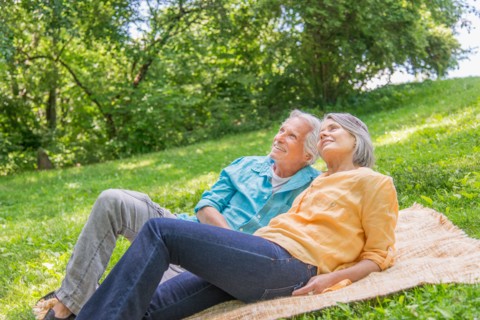 Central Park, New York City. Senior couple relaxing in park.