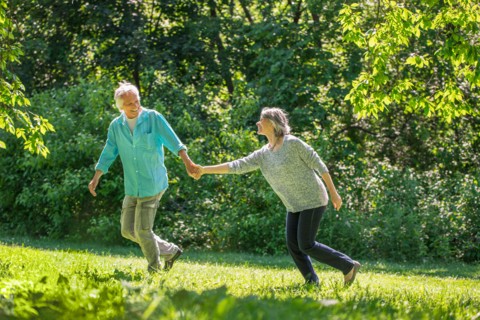 Central Park, New York City. Senior couple running in park.