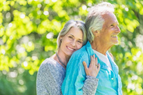 Central Park, New York City. Senior couple embracing in park.
