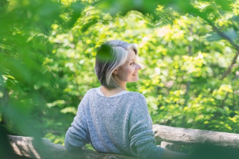 Central Park, New York City. Senior woman relaxing in park.