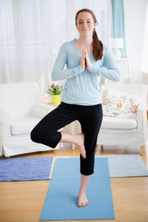 Teenage girl (14-15) practicing yoga