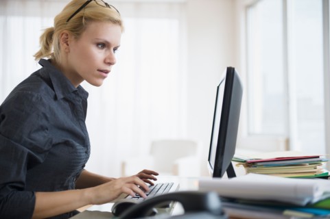 Young woman working at desk in office