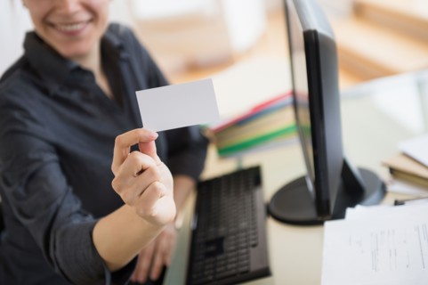Young woman showing blank business card