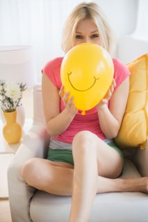 Young woman blowing balloon