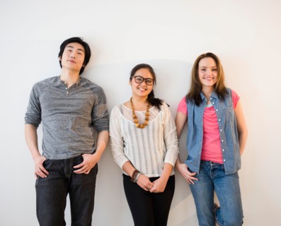 Portrait of young women and man against white wall