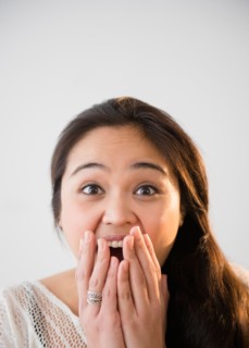 Studio shot of beautiful young woman laughing