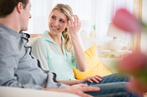 Couple talking on sofa