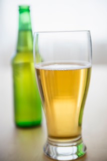 Studio shot of glass of beer and beer bottle