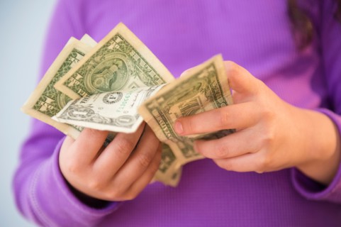 Girl (8-9) counting money