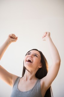 Young woman in victorious gesture