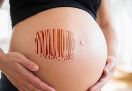 Mid section of pregnant woman with bar code on her belly