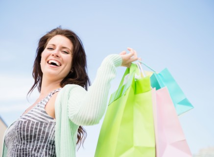 Happy woman holding shopping bags