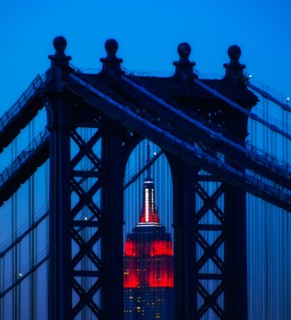 Williamsburg Bridge in front of Empire State Building at night
