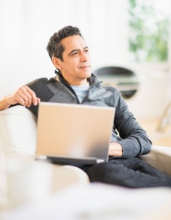 Portrait of man working on laptop at home