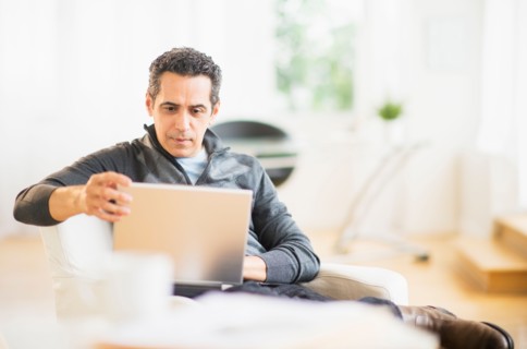 Portrait of man working on laptop at home